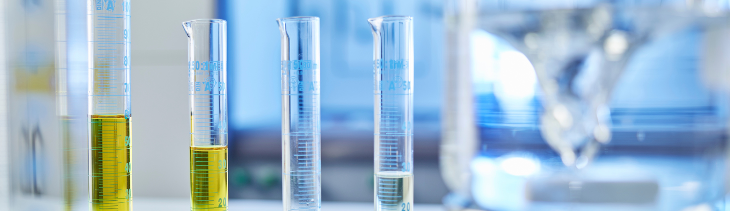 Beakers filled with CASE formulations sit on a lab table