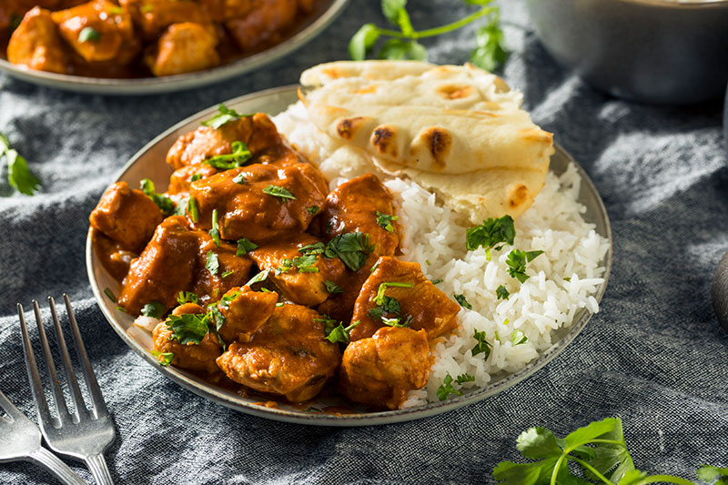 Curry & Rice with Naan Bread in a metal bowl