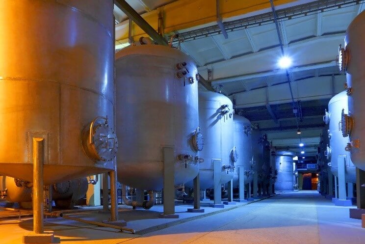 A row of chemical blending and manufacturing tanks 