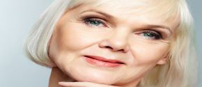 Close up of a woman with straight, sleek gray hair