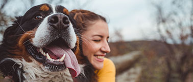 Woman hugging a large dog outdoors