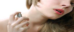 Woman applying perfume